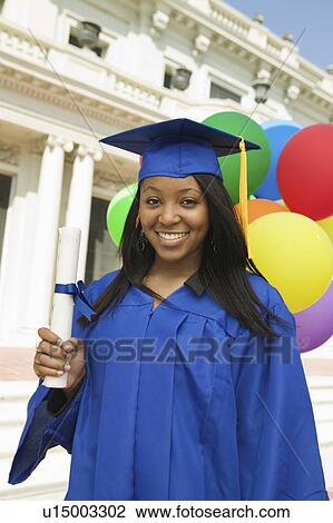 Graduate holding diploma outside university, portrait View Large Photo Image Stock Image - Graduate holding diploma outside university, portrait. Fotosearch