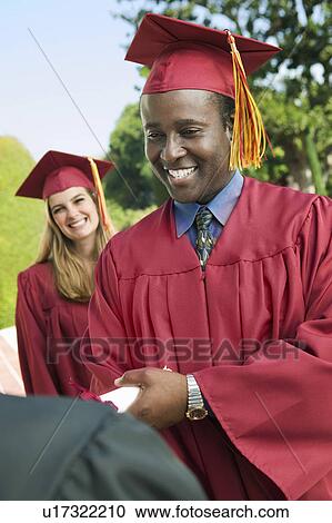 Graduate shaking hand of dean outside View Large Photo Image Stock Image - Graduate shaking hand of dean outside. Fotosearch
