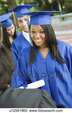 Graduate shaking hand of dean outside View Large Photo Image Stock Photography - Graduate shaking hand of dean outside. Fotosearch