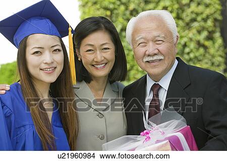 Graduate with mother and grandfather outside, portrait View Large Photo Image Picture - Graduate with mother and grandfather outside, portrait. Fotosearch