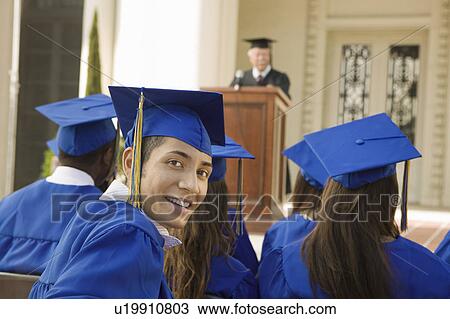 Graduates listening to speaker outside View Large Photo Image Stock Image - Graduates listening to speaker outside. Fotosearch