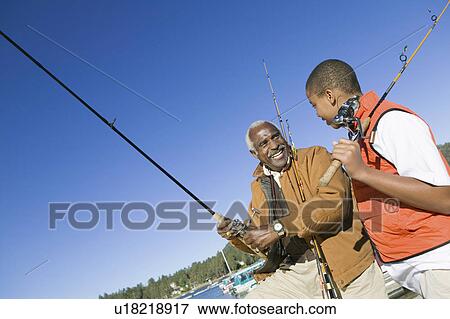 Grandfather and grandson fishing View Large Photo Image Stock Photo - Grandfather and grandson fishing. Fotosearch
