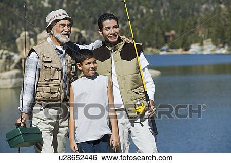 Grandfather and two grandsons holding fishing rods, standing by lake View Large Photo Image Stock Photograph - Grandfather and two grandsons holding fishing rods, standing by lake. Fotosearch