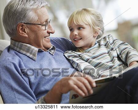 Grandfather reading to girl (3-4), close-up View Large Photo Image Stock Image - Grandfather reading to girl (3-4), close-up. Fotosearch