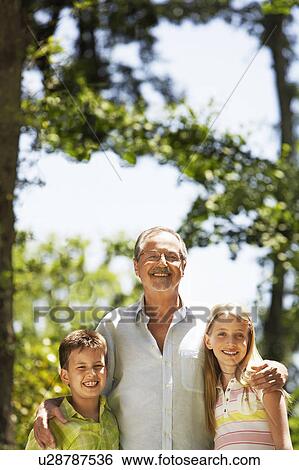 Grandfather with Grandchildren in back yard, portrait View Large Photo Image Stock Photograph - Grandfather with Grandchildren in back yard, portrait. Fotosearch