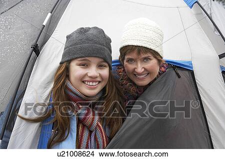 Picture - Grandmother and granddaughter (10-12) in tent, (portrait). Fotosearch