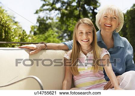 Grandmother and granddaughter on sofa in back yard, portrait View Large Photo Image Stock Image - Grandmother and granddaughter on sofa in back yard, portrait. Fotosearch
