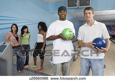 Group of friends at bowling alley, some holding balls, portrait View Large Photo Image Stock Photograph - Group of friends at bowling alley, some holding balls, portrait. Fotosearch