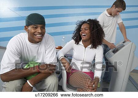 Stock Photograph - Group of friends at bowling alley. Fotosearch
