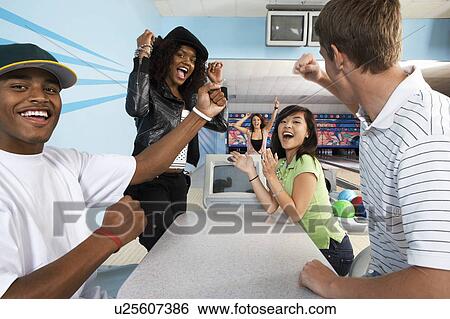 Group of friends celebrating at bowling alley, portrait View Large Photo Image Stock Photograph - Group of friends celebrating at bowling alley, portrait. Fotosearch