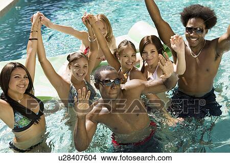 Group of friends in swimming pool, high angle view, portrait View Large Photo Image Picture - Group of friends in swimming pool, high angle view, portrait. Fotosearch