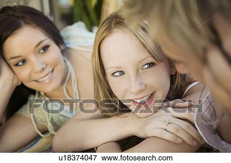 Group of friends lying down, close up View Large Photo Image Stock Photo - Group of friends lying down, close up. Fotosearch