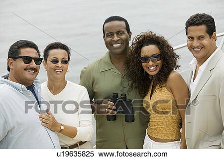 Stock Photography - Group of friends relaxing on yacht, (portrait). Fotosearch