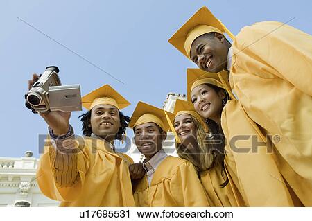 Group of graduates using video camera outside, low angle view View Large Photo Image Stock Image - Group of graduates using video camera outside, low angle view. Fotosearch