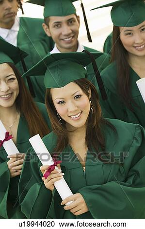 Stock Image - Group of graduates with diplomas, elevated view. Fotosearch