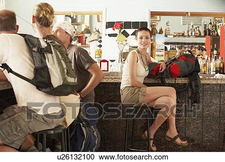 Group of hikers sitting in bar View Large Photo Image Stock Image - Group of hikers sitting in bar. Fotosearch
