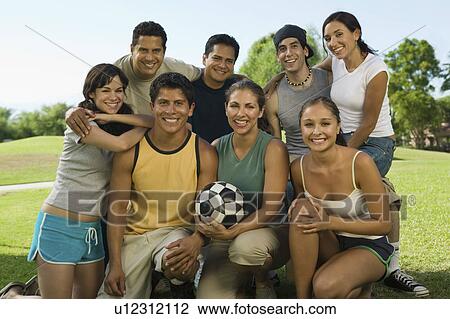 Group of people in park with woman holding soccer ball. View Large Photo Image Stock Image - Group of people in park with woman holding soccer ball.. Fotosearch