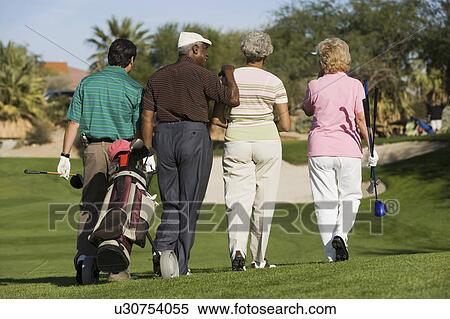 Group of senior golfers walking on golf course, back view View Large Photo Image Stock Photography - Group of senior golfers walking on golf course, back view. Fotosearch