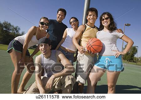 Group of young adults at basketball court. View Large Photo Image Stock Photo - Group of young adults at basketball court.. Fotosearch