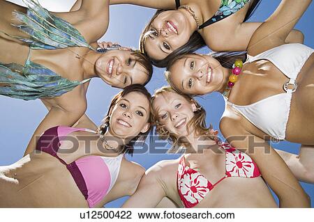 Group of young women in circle, view from below, portrait View Large Photo Image Stock Image - Group of young women in circle, view from below, portrait. Fotosearch