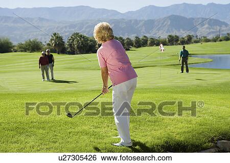Stock Photograph - Group senior golfers on golf course. Fotosearch