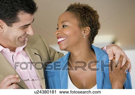 Happy man with arm around partner indoors, close up View Large Photo Image Stock Image - Happy man with arm around partner indoors, close up. Fotosearch