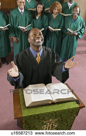 Happy preacher with Bible at church altar looking up, high angle view View Large Photo Image Stock Image - Happy preacher with Bible at church altar looking up, high angle view. Fotosearch