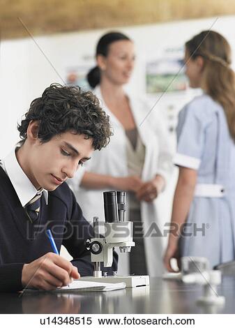 High school student using microscope and taking notes in classroom View Large Photo Image Stock Photography - High school student using microscope and taking notes in classroom. Fotosearch