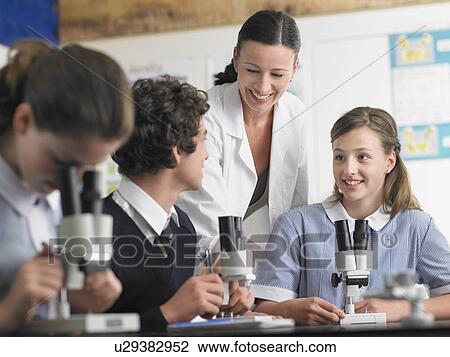 High school students talking with teacher in chemistry class View Large Photo Image Stock Image - High school students talking with teacher in chemistry class. Fotosearch