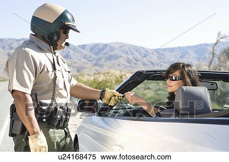 Stock Photography - Highway patrol officer with female driver. Fotosearch