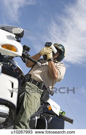 Highway patrol officer with speed radar View Large Photo Image Stock Image - Highway patrol officer with speed radar. Fotosearch