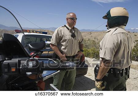 Stock Photo - Highway patrol officers with vehicles. Fotosearch