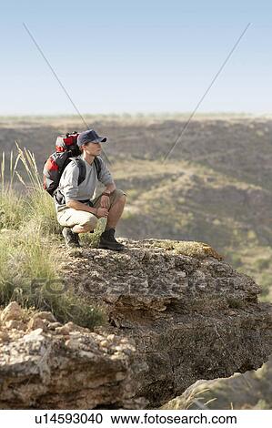 Hiker standing on top of mountain View Large Photo Image Stock Image - Hiker standing on top of mountain. Fotosearch