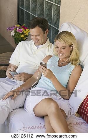 Husband and Wife Using Gadgets on Patio View Large Photo Image Stock Image - Husband and Wife Using Gadgets on Patio. Fotosearch