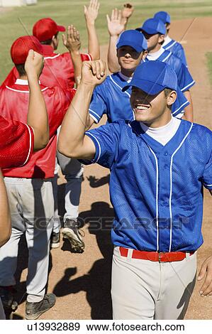 Line of baseball players giving each other high fives View Large Photo Image Stock Photo - Line of baseball players giving each other high fives. Fotosearch