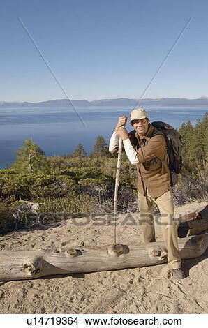 Picture - Male hiker on coastal track, (portrait). Fotosearch