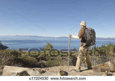Stock Image - Male hiker on coastal track. Fotosearch