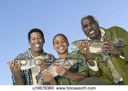 Male members of three generation family showing fishes, smiling, (portrait) View Large Photo Image Stock Image - Male members of three generation family showing fishes, smiling, (portrait). Fotosearch