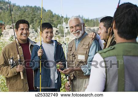 Male members of three generation family holding fishing rods outdoors, smiling View Large Photo Image Stock Photo - Male members of three generation family holding fishing rods outdoors, smiling. Fotosearch