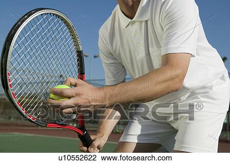 Male Tennis Player Preparing to Serve, mid section, low angle view View Large Photo Image Stock Image - Male Tennis Player Preparing to Serve, mid section, low angle view. Fotosearch