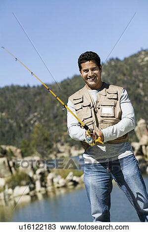 Man fly fishing, (portrait) View Large Photo Image Stock Image - Man fly fishing, (portrait). Fotosearch