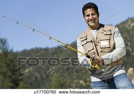 Stock Photography - Man fly fishing, (portrait). Fotosearch