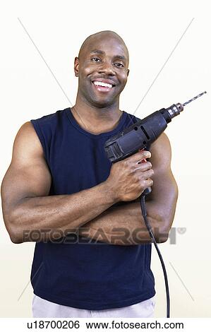 Man holding power drill, portrait View Large Photo Image Stock Photograph - Man holding power drill, portrait. Fotosearch
