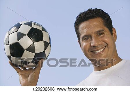 Stock Photo - Man Holding Soccer Ball, close-up. Fotosearch