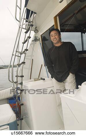 Stock Photograph - Man on boat, (portrait). Fotosearch