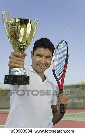 Man on tennis court Holding Trophy, portrait View Large Photo Image Picture - Man on tennis court Holding Trophy, portrait. Fotosearch