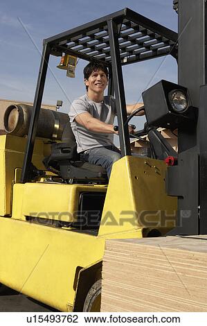 Man operating forklift outside View Large Photo Image Stock Image - Man operating forklift outside. Fotosearch