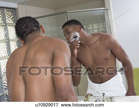 Man shaving in front of bathroom mirror View Large Photo Image Stock Photo - Man shaving in front of bathroom mirror. Fotosearch