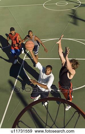 Stock Photo - Man shooting basketball, elevated view. Fotosearch