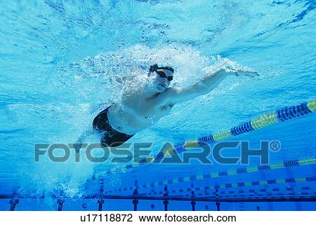Stock Image - Man Swimming in Pool. Fotosearch